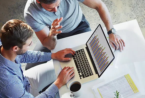 two business men looking at a laptop